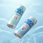 Two cans of Aqua Libra water on a light blue background