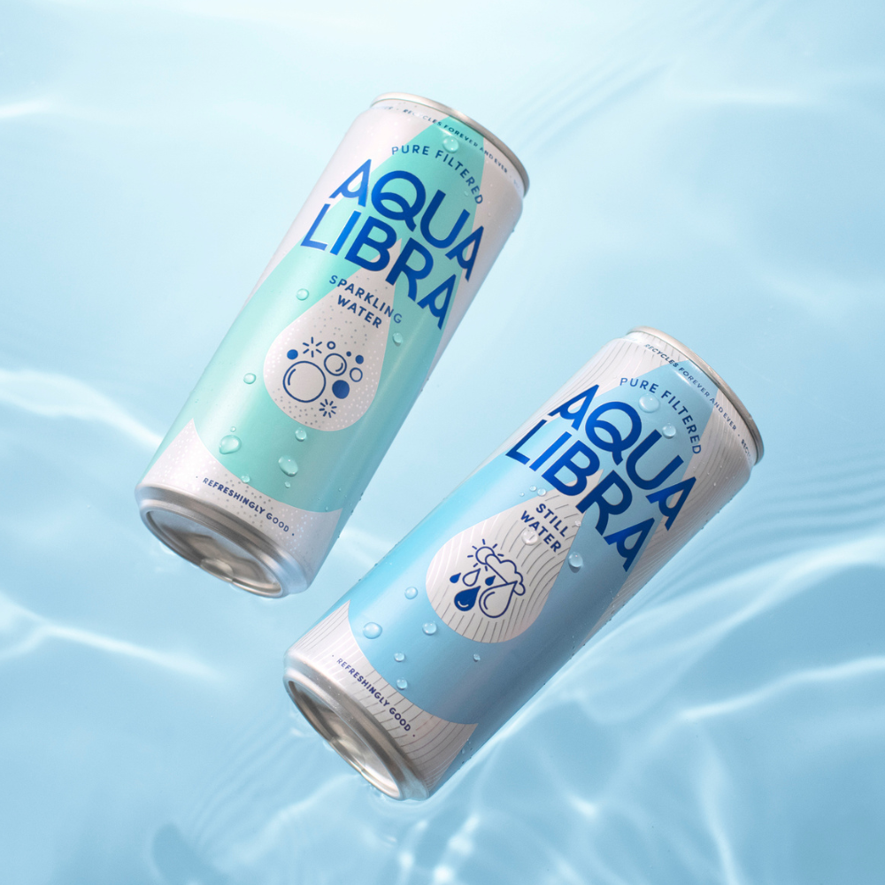 Two cans of Aqua Libra water on a light blue background
