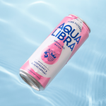 Aqua Libra sparkling water can with raspberry and blackcurrant flavor on a light blue background