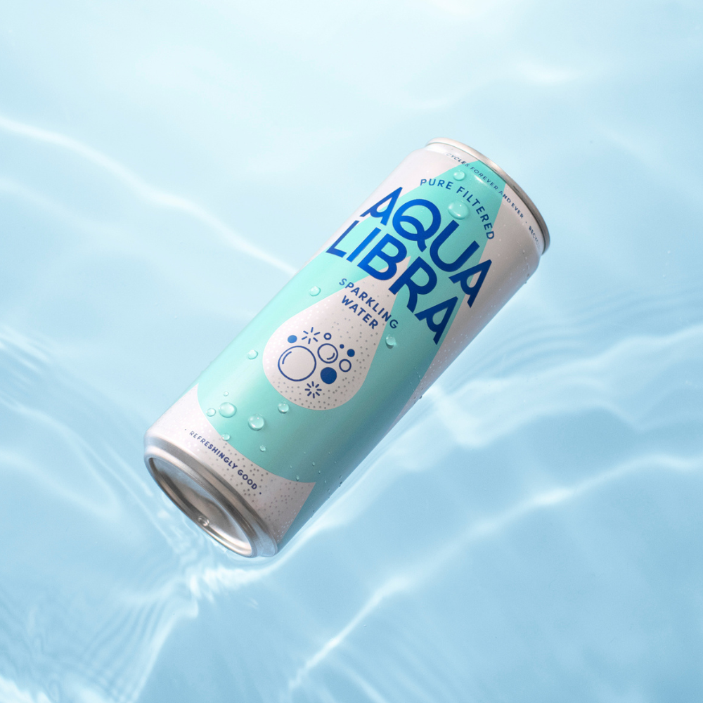 Aqua Libra sparkling water can on a light blue water background